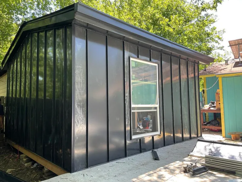 Black standing seam metal wall panels for Roof Inspection in Moody